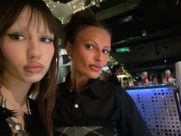 Two women photographed together indoors in London