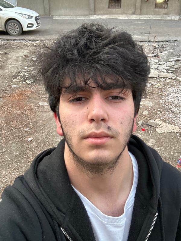 Man photographed outdoors, TV screen shows media collection scene