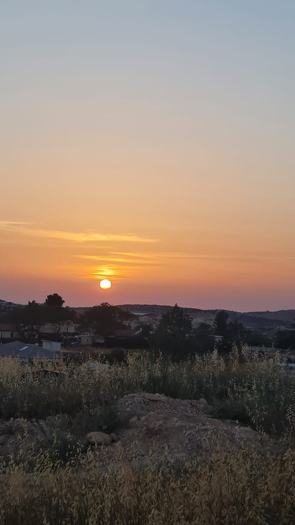 Sunset sequence documented over rural Israel agricultural landscape