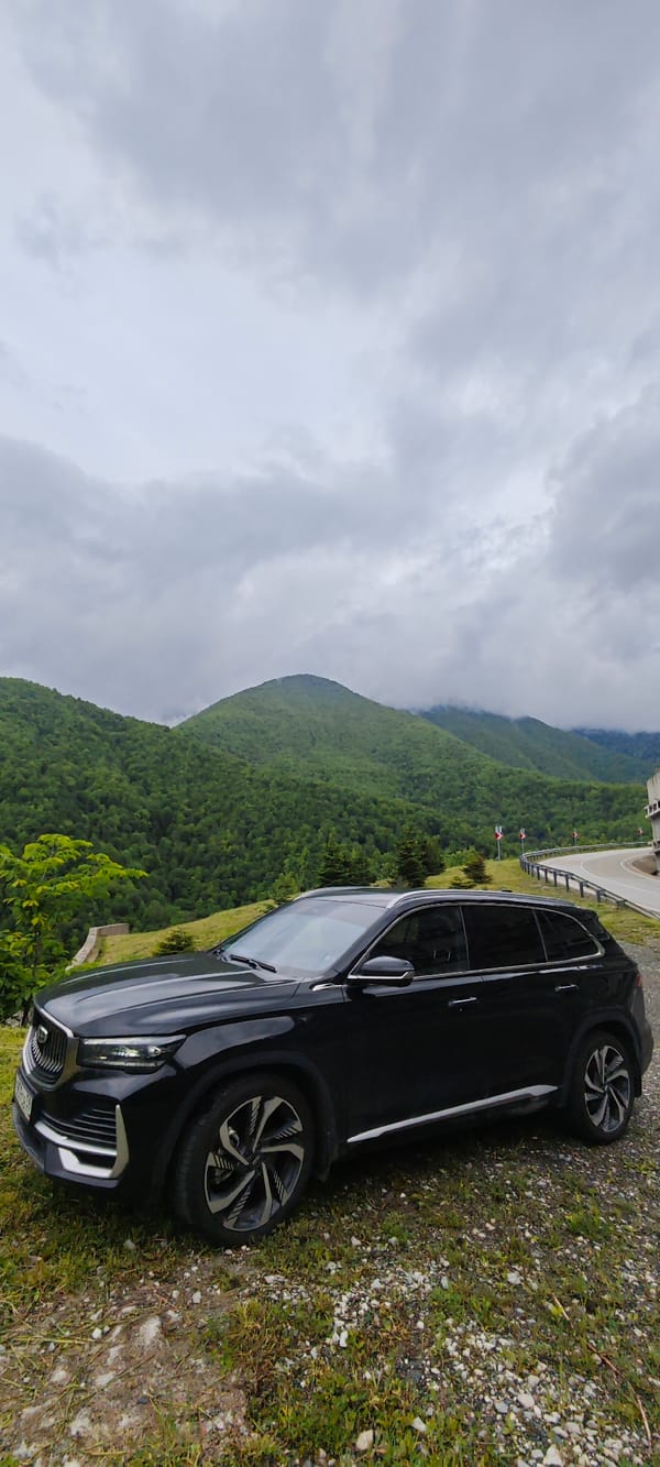 Black SUV parked on mountain road in Chvizhepse, Russia
