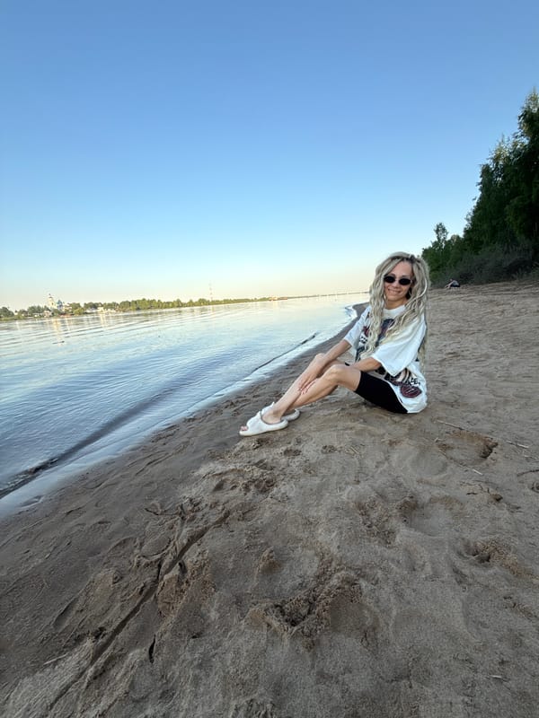 Woman enjoys riverside afternoon in Rusanovo, Russia