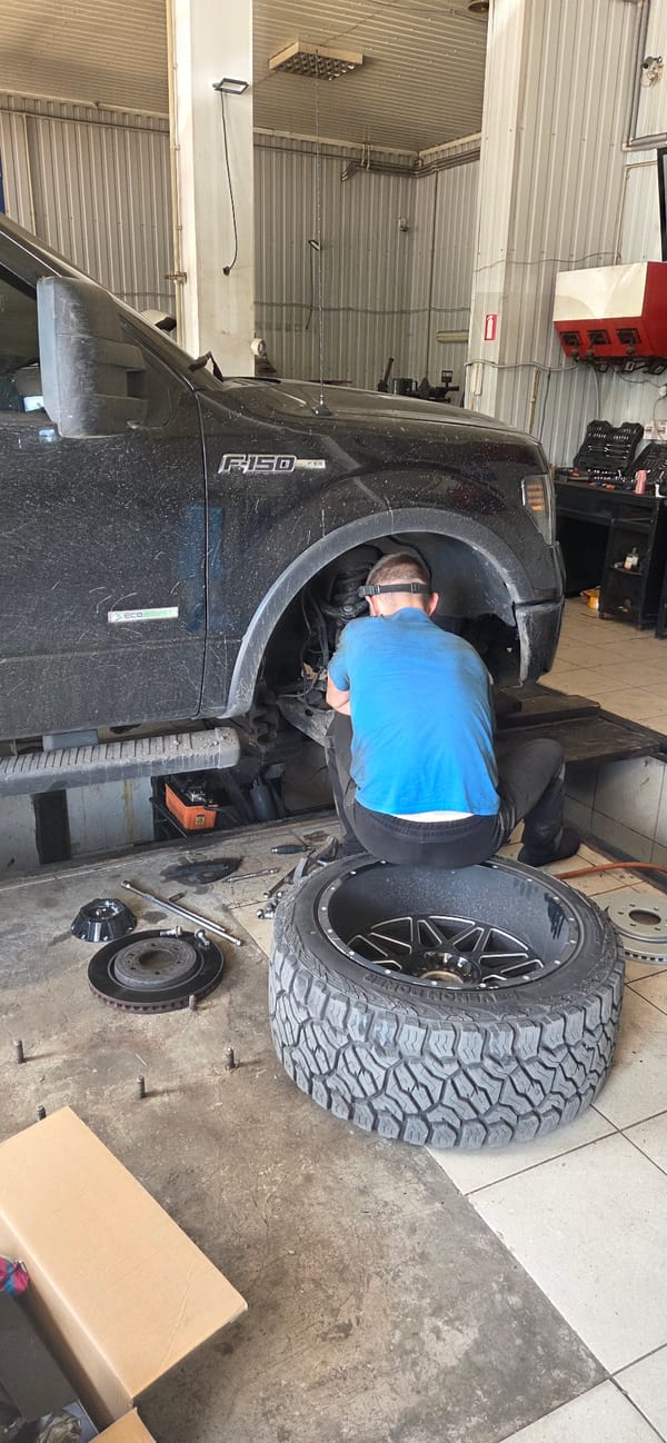 Auto service activity across a Donetsk vehicle repair strip