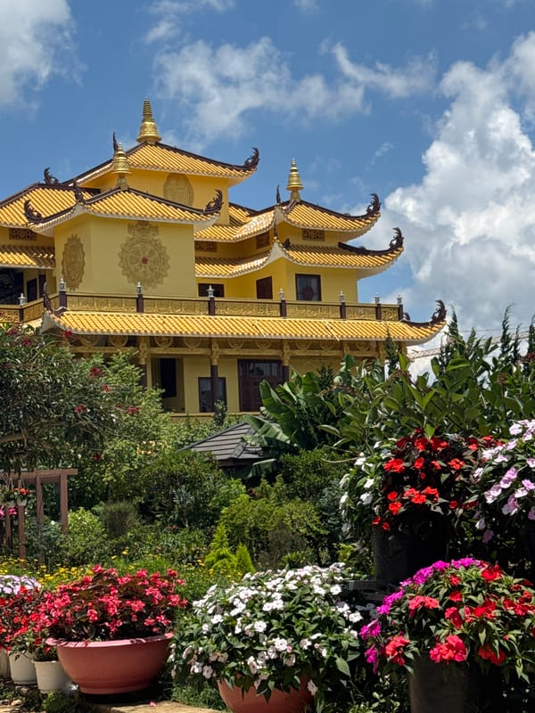 Golden tiered building with traditional architecture observed in Da Lat