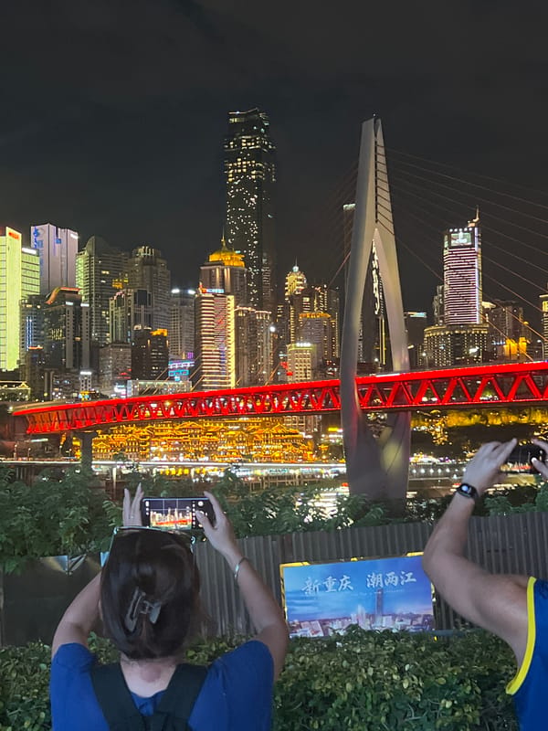 Chongqing's Jiangbeicheng skyline and red bridge lit up at night