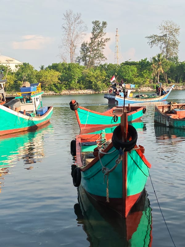 Colorful fishing boats in Lhokseumawe harbor waters