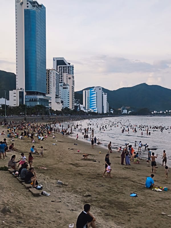 Busy morning at Nha Trang beach, swimmers and strollers out in force
