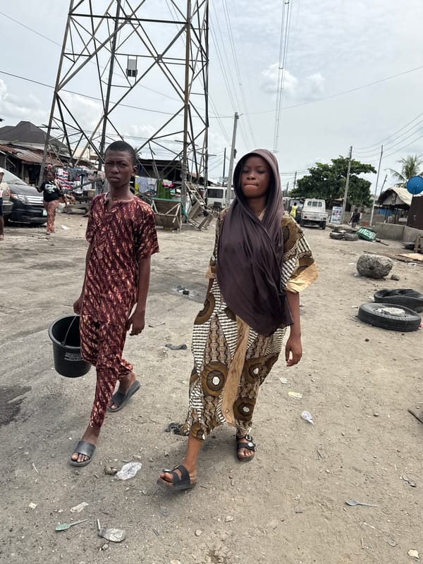 Two people spotted on dirt road in Ado, Nigeria