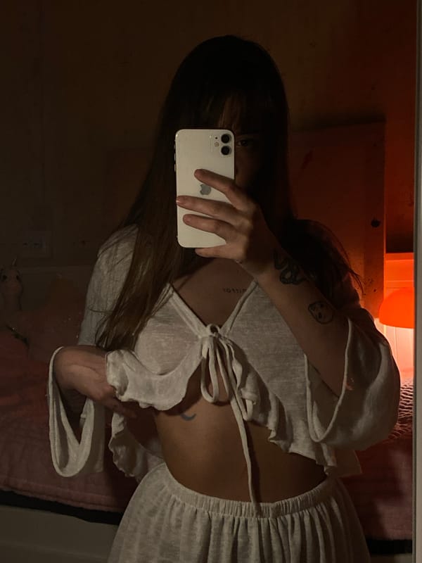 Person takes selfies with white phone in Votkinsk apartment