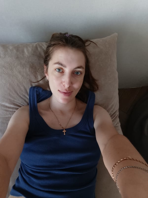 Woman takes morning selfies with gray tabby cat in Russia