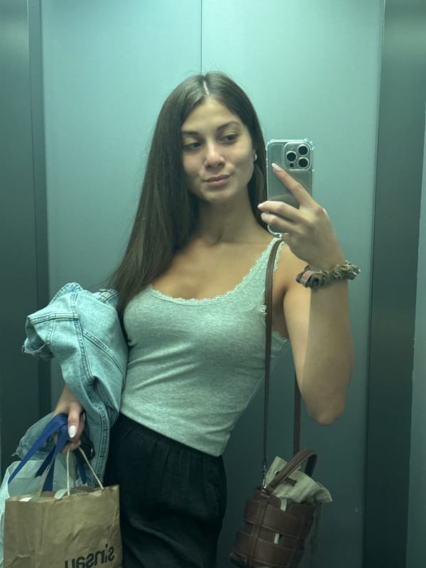 Woman takes mirror selfie in Burgas interior space