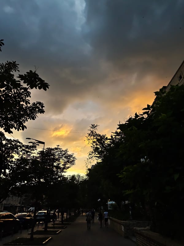 Storm clouds meet golden sunset over a Kyiv street