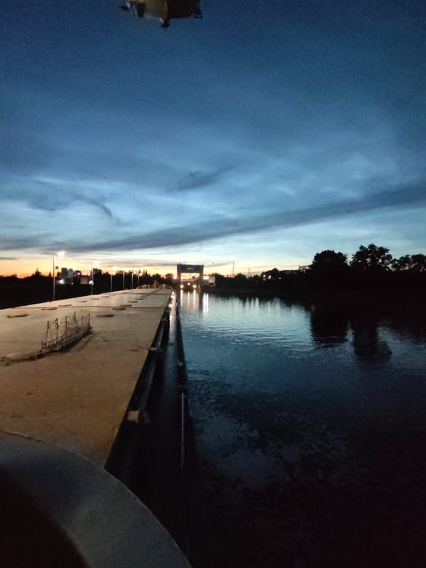Cruise ship Andrei Rublev locks through Sheksna canal at dusk