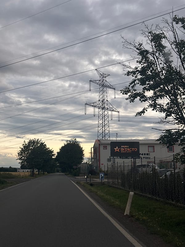Overcast streets and rural outskirts under heavy clouds