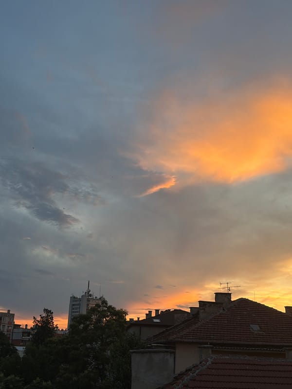 Dramatic sunset illuminates city skyline with vibrant colors