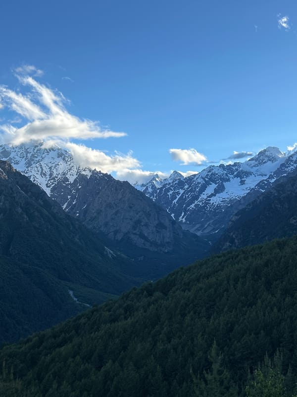 Snow-capped peaks and pine forest in Abaitikau, Russia