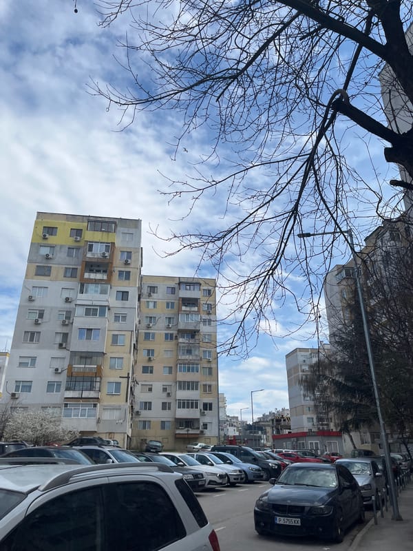 Street scene with parked cars and residential buildings in Varna