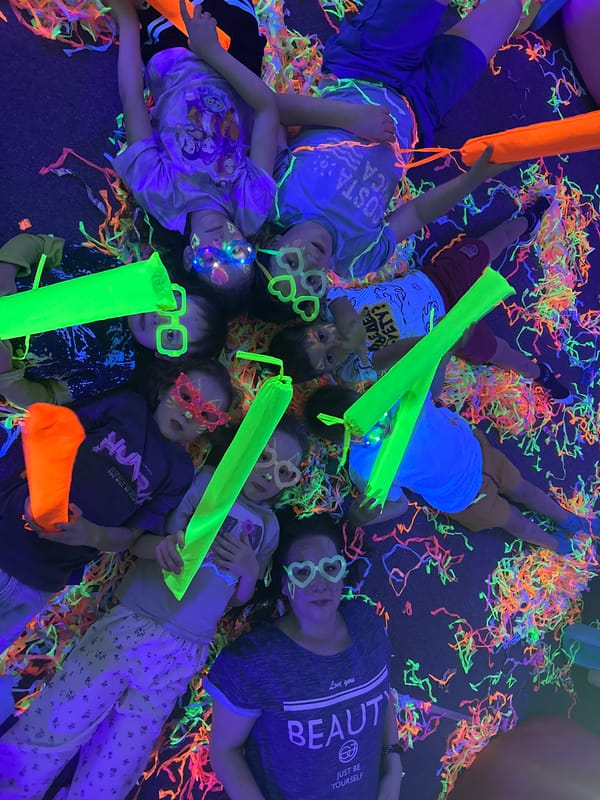 Children's blacklight party features UV face paint and confetti