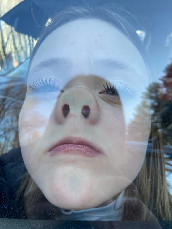 Young person photographed in car reflections in Chaikovsky