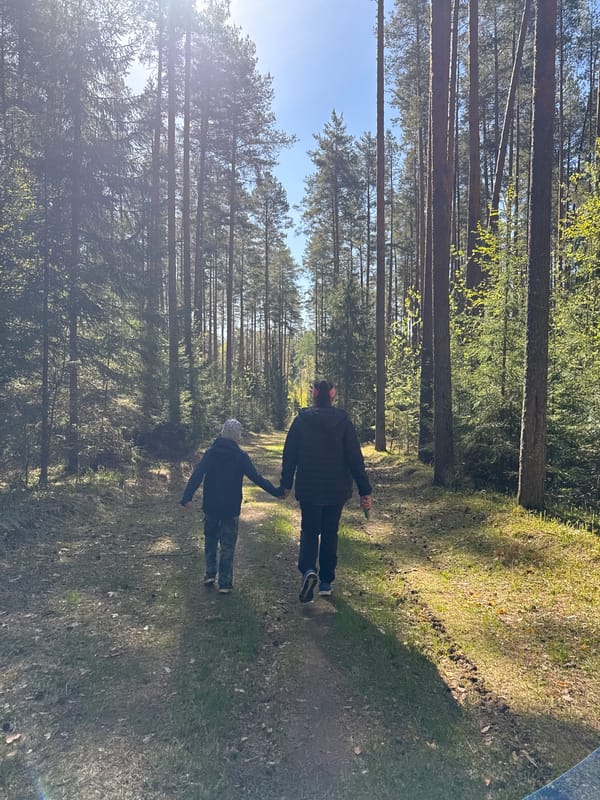 Family group walks forest paths in Chaikovsky, Russia