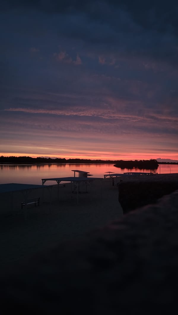 Sitting quietly by the water at sunset