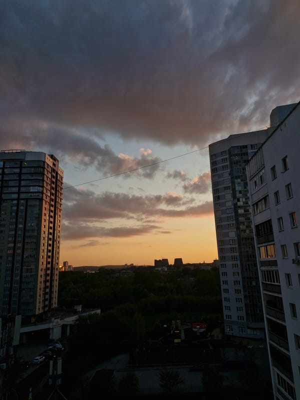Woman photographed on balcony during dusk in Yekaterinburg