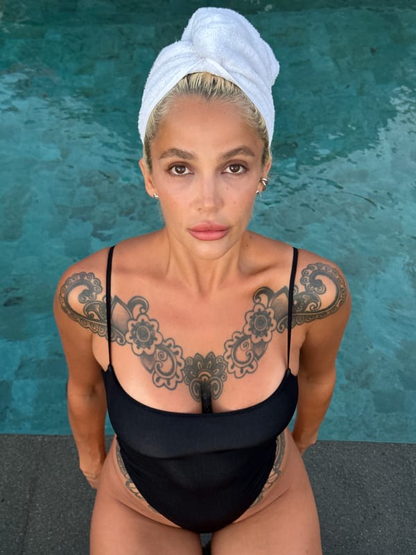 Tattooed woman poses for poolside selfies in Kuta Selatan