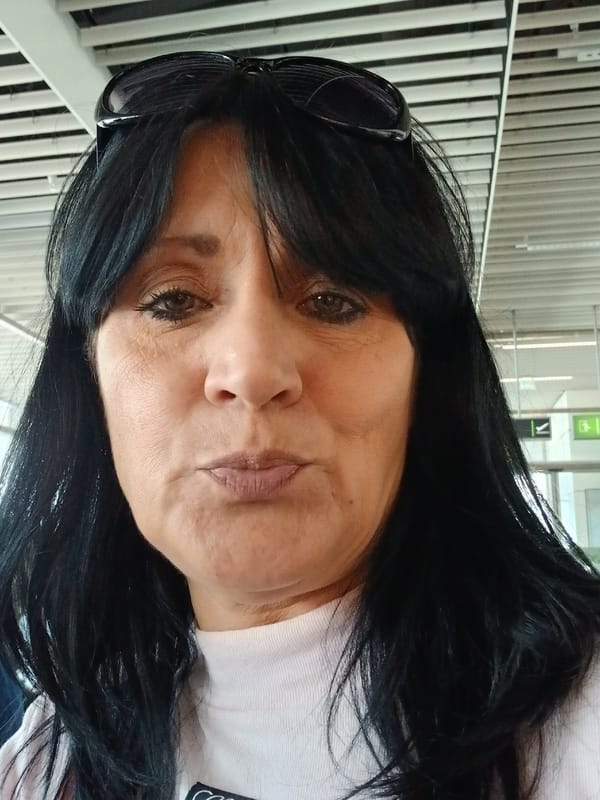 Woman with sunglasses photographed indoors at unknown location