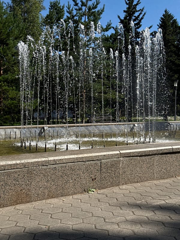 Sunny morning at a Kokshetau park fountain and walkways
