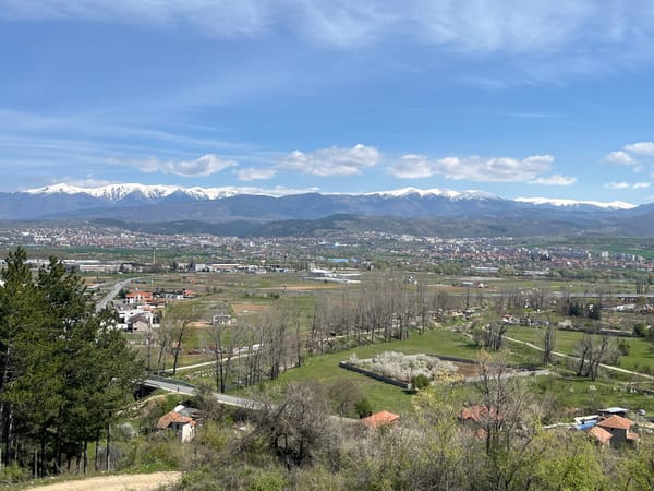 Valley city and hillside cross captured in mountain vista