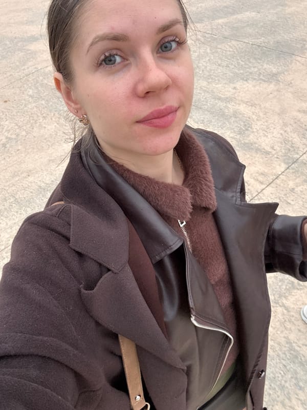 Woman takes selfie near modern buildings in Batumi