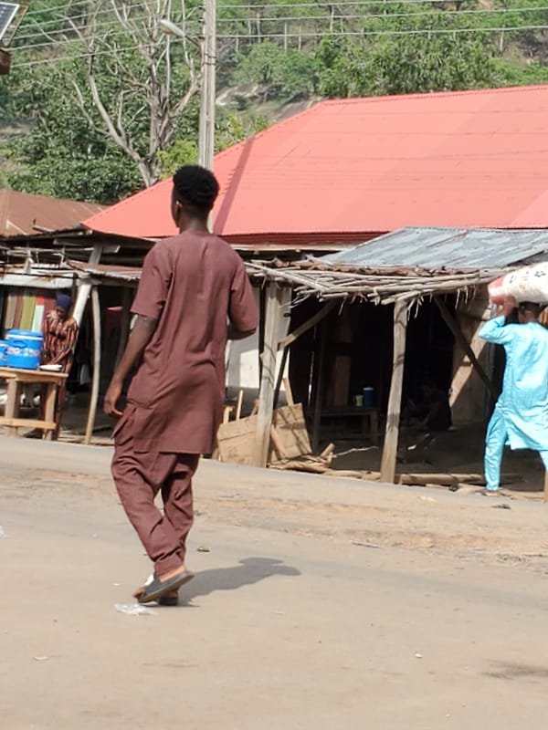 Person in traditional dress photographed outdoors in Mararaba, Nigeria