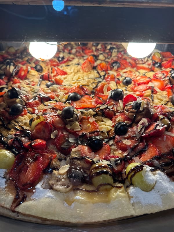 Evening festivities in Budva's Old Town feature live music, dessert pizza