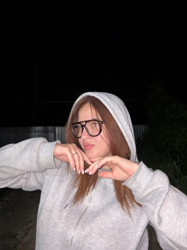 Woman photographed posing outdoors at night in Novopokrovskaya