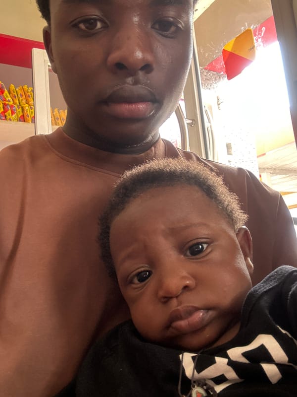 Adult and child take selfies in Jos shop