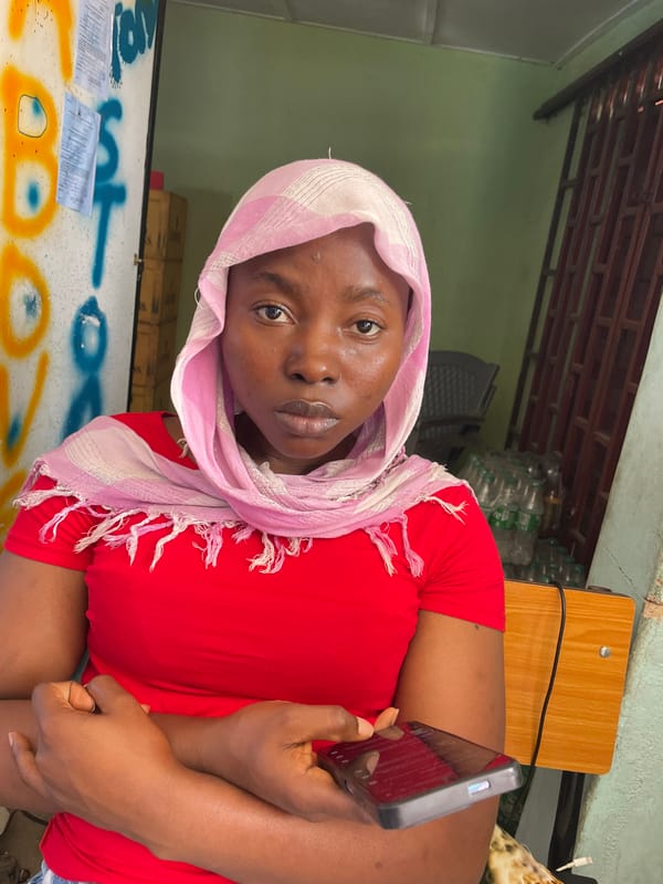 Woman with smartphone observed resting in Jos, Nigeria