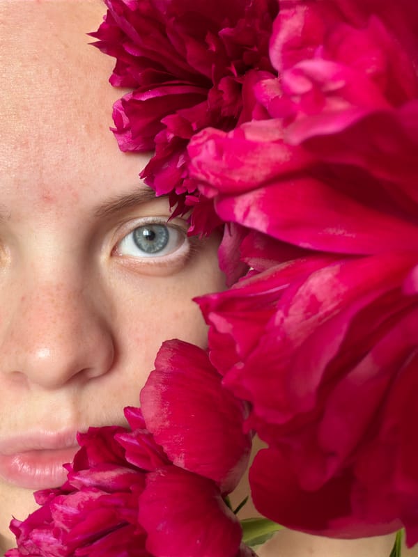 Woman poses with peony flowers in artistic photo session