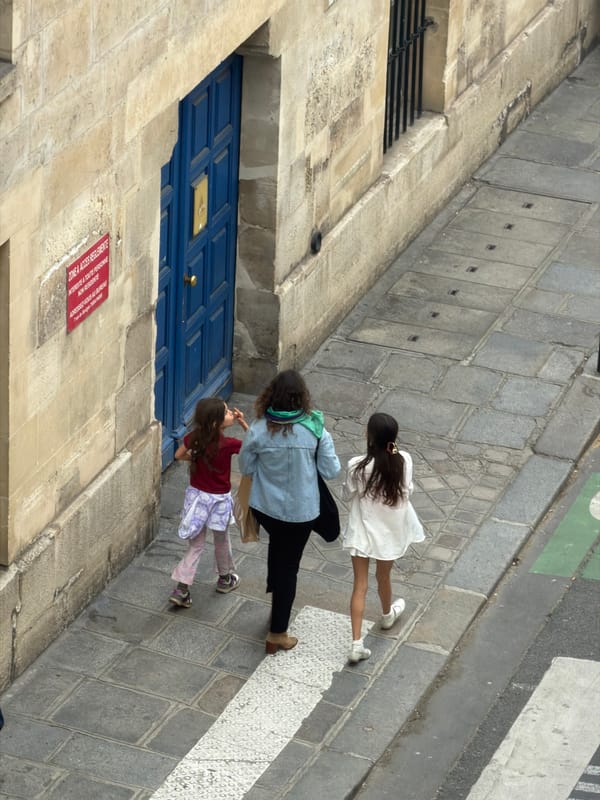 Pedestrians Navigate Paris Streets During Afternoon Rush