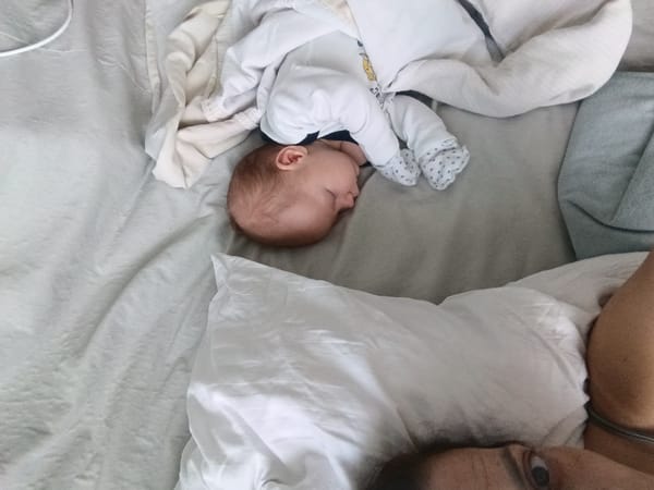 Baby sleeps peacefully beside guardian in Andreyevo home