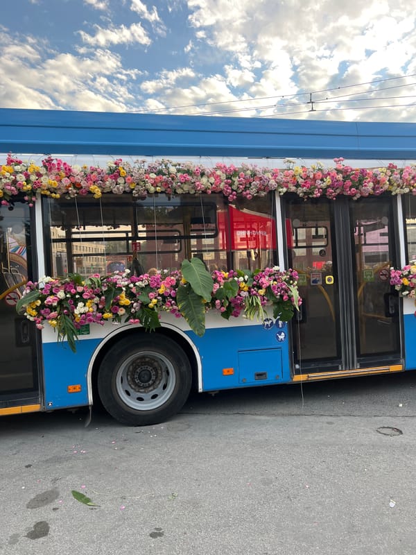 Flower-covered bus and street gathering in Novosibirsk