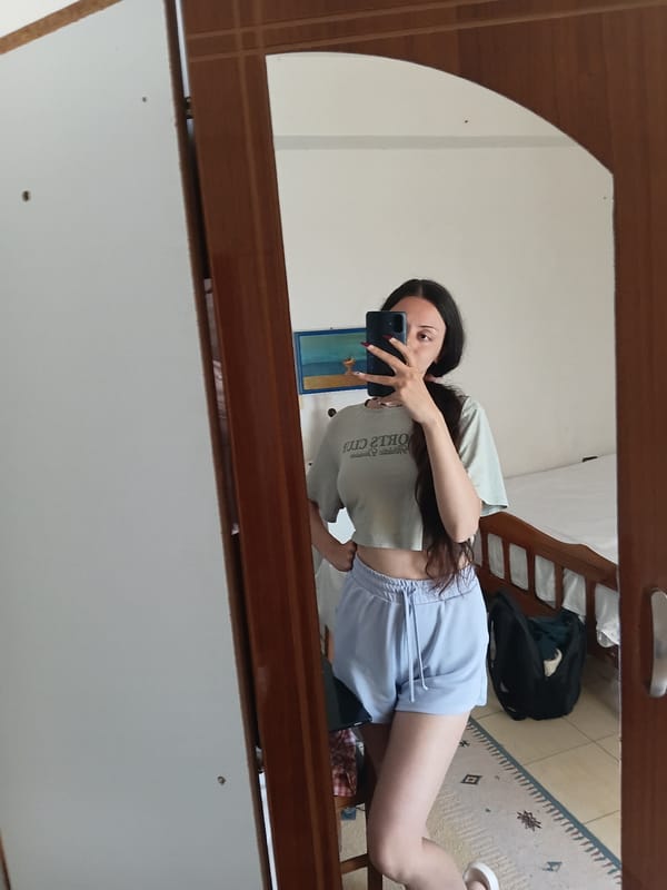 Woman takes morning selfies in bedroom mirror, Vlora Albania