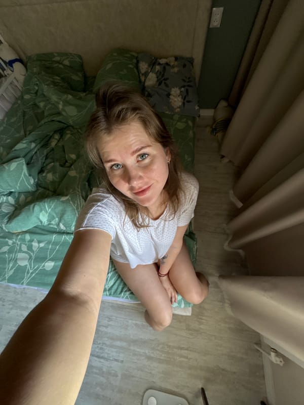 Woman poses for photos on bed in Russia