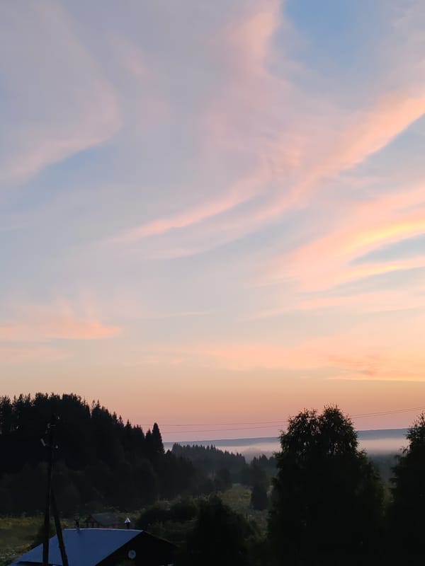 Dusk sky over rural Chukhloma, crescent moon and fading color