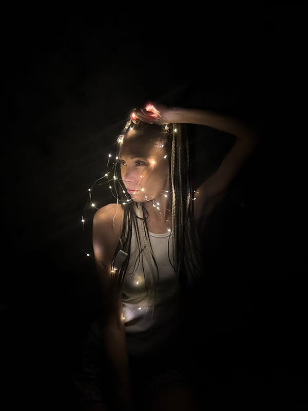 Person rests among fairy lights in Zhukovo, Russia
