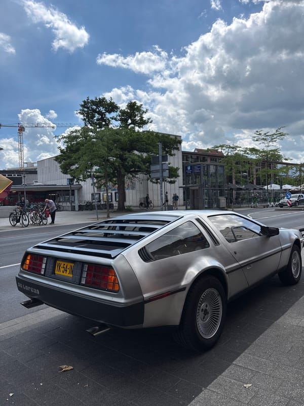 DeLorean parked in sunny Hanover, near cafe and fountain