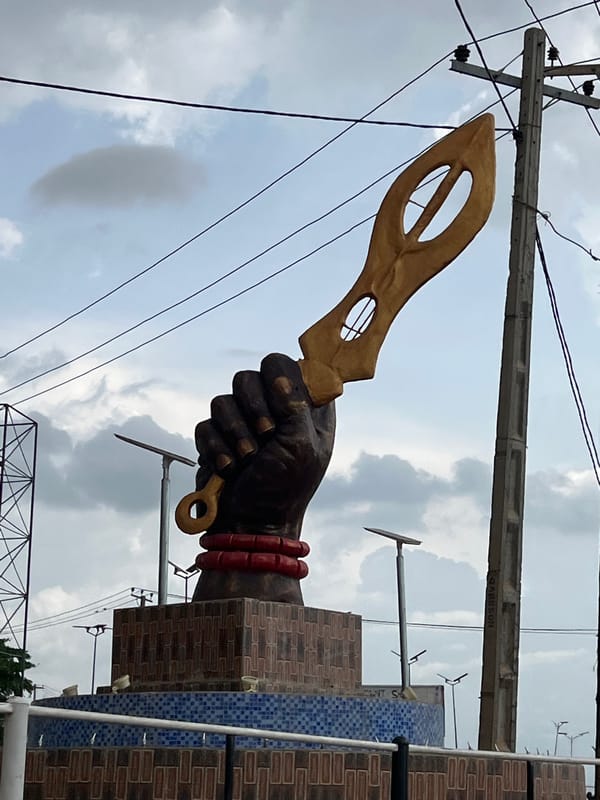 Street life and a landmark monument in Onitsha, Nigeria