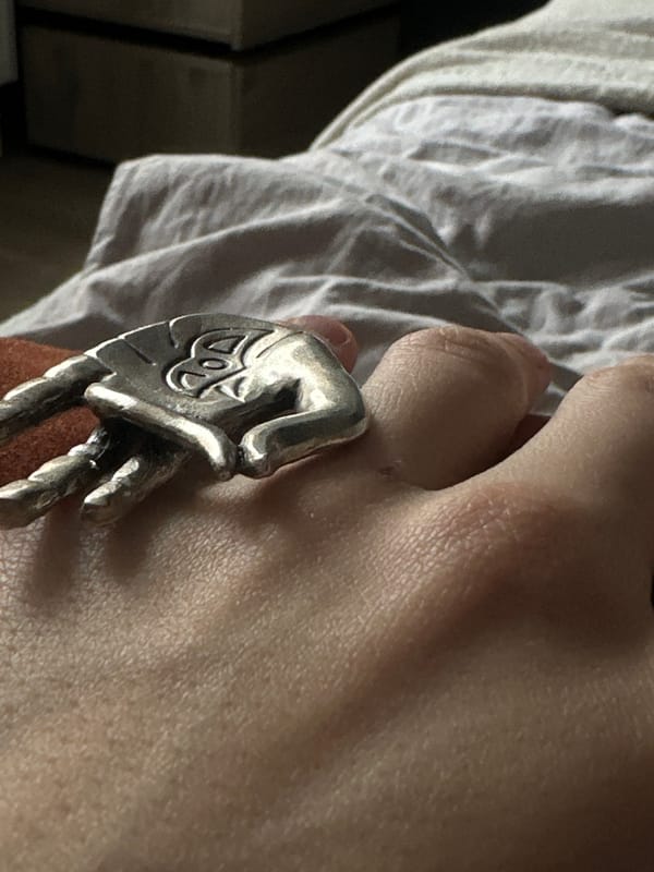 Person displays detailed hand-shaped silver ring in Saint Petersburg