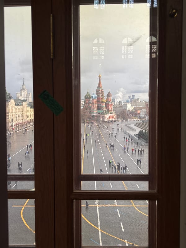 Museum visitors document Red Square views, ornate carriage display