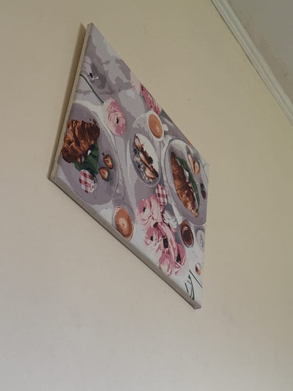Framed breakfast still life print on a wall in Horenychi