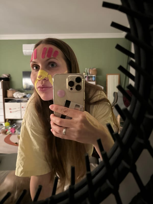 Woman documents skincare routine with kinesiology tape in Fethiye