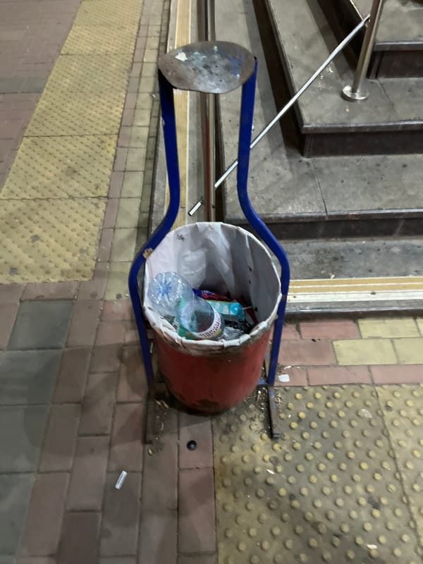 Night driving through the city, trash bin on a nearby sidewalk